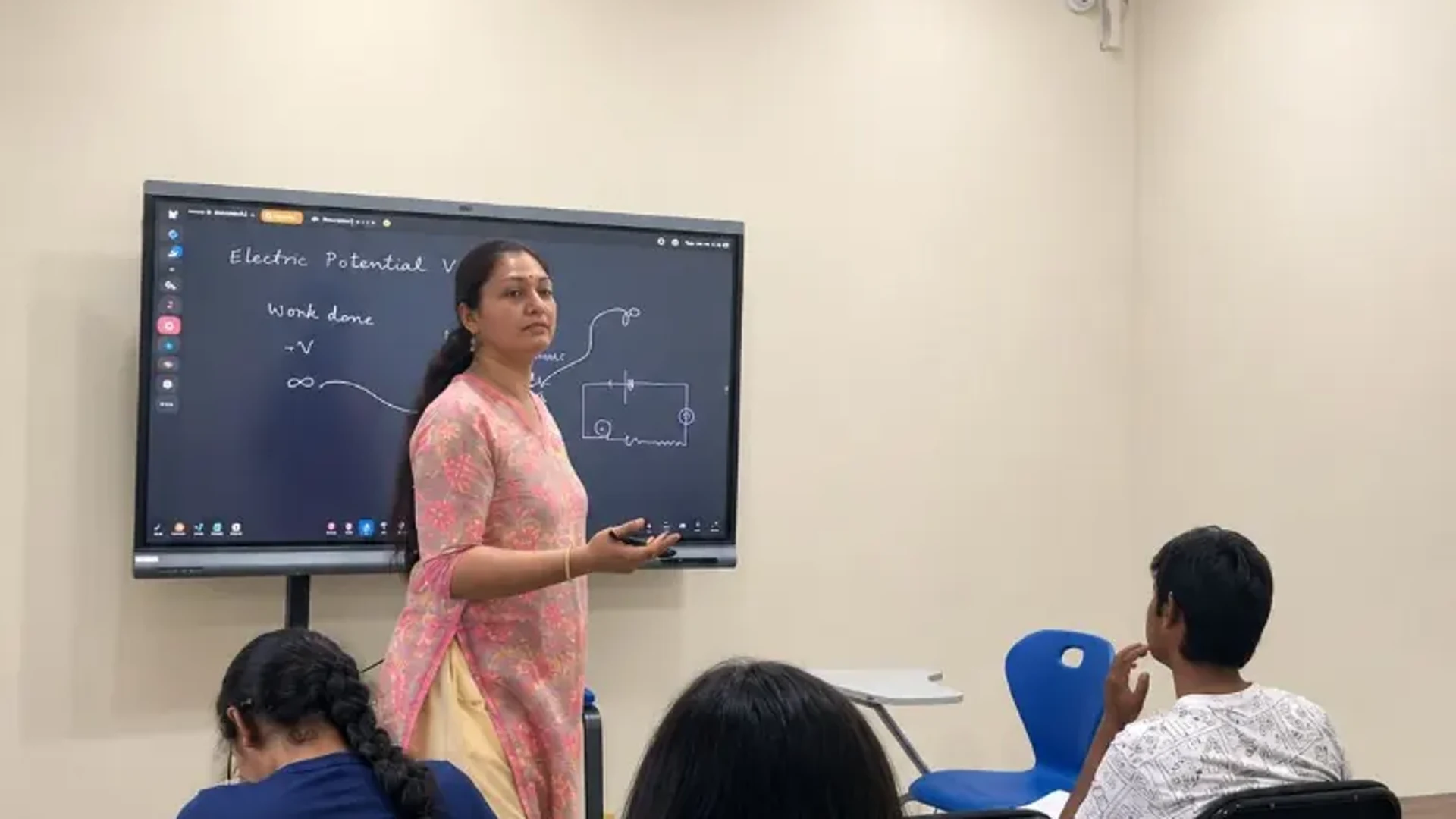 Catalyst Classes teacher explaining concepts on a smart digital board to students in a Hyderabad tuition classroom